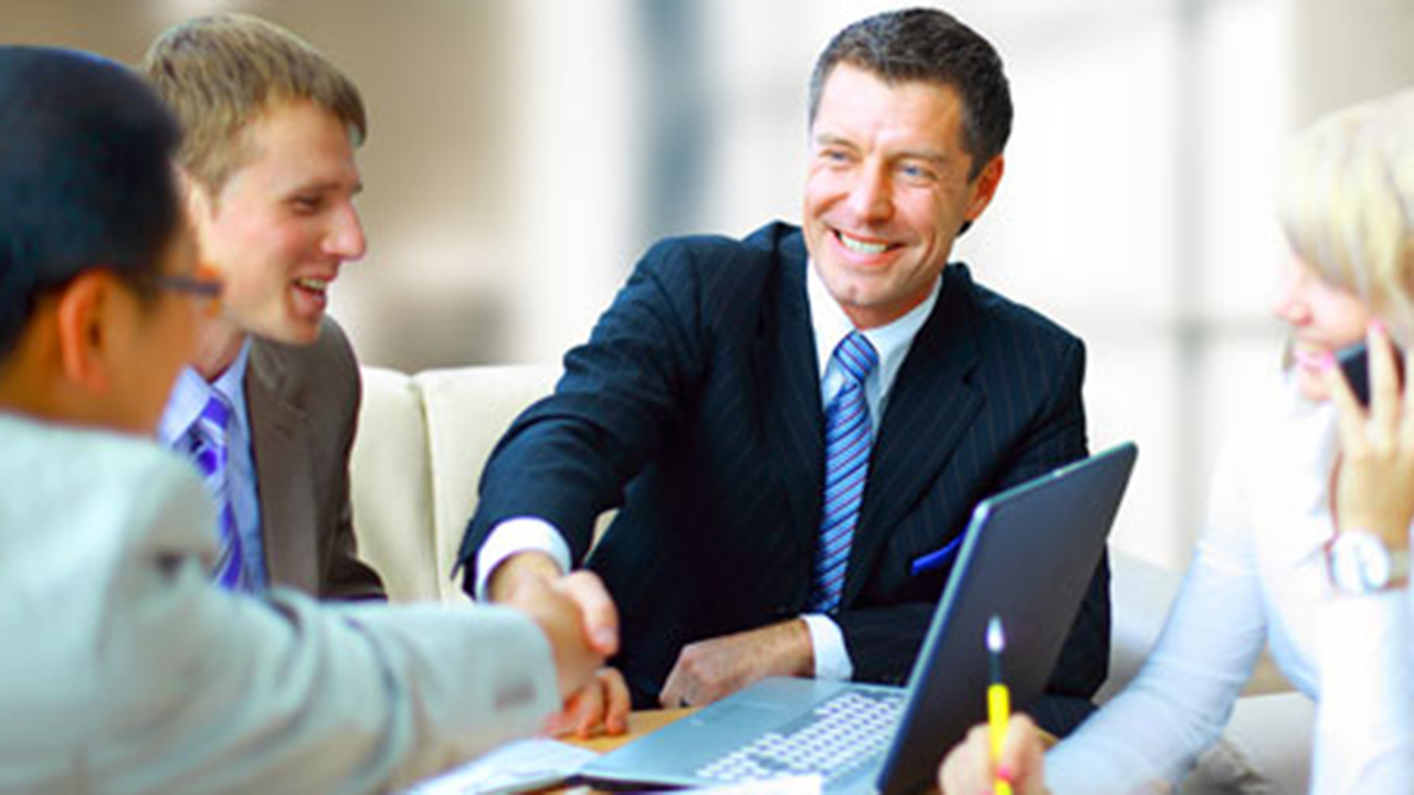 Man shaking colleagues hand during meeting