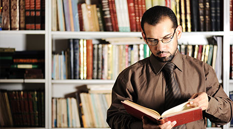 A criminolgy student researching in a library.