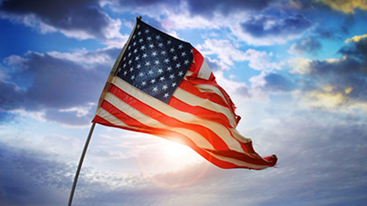 Protecting the U.S. from threats symbolized by a U.S. flag in front of a beautiful sunset.