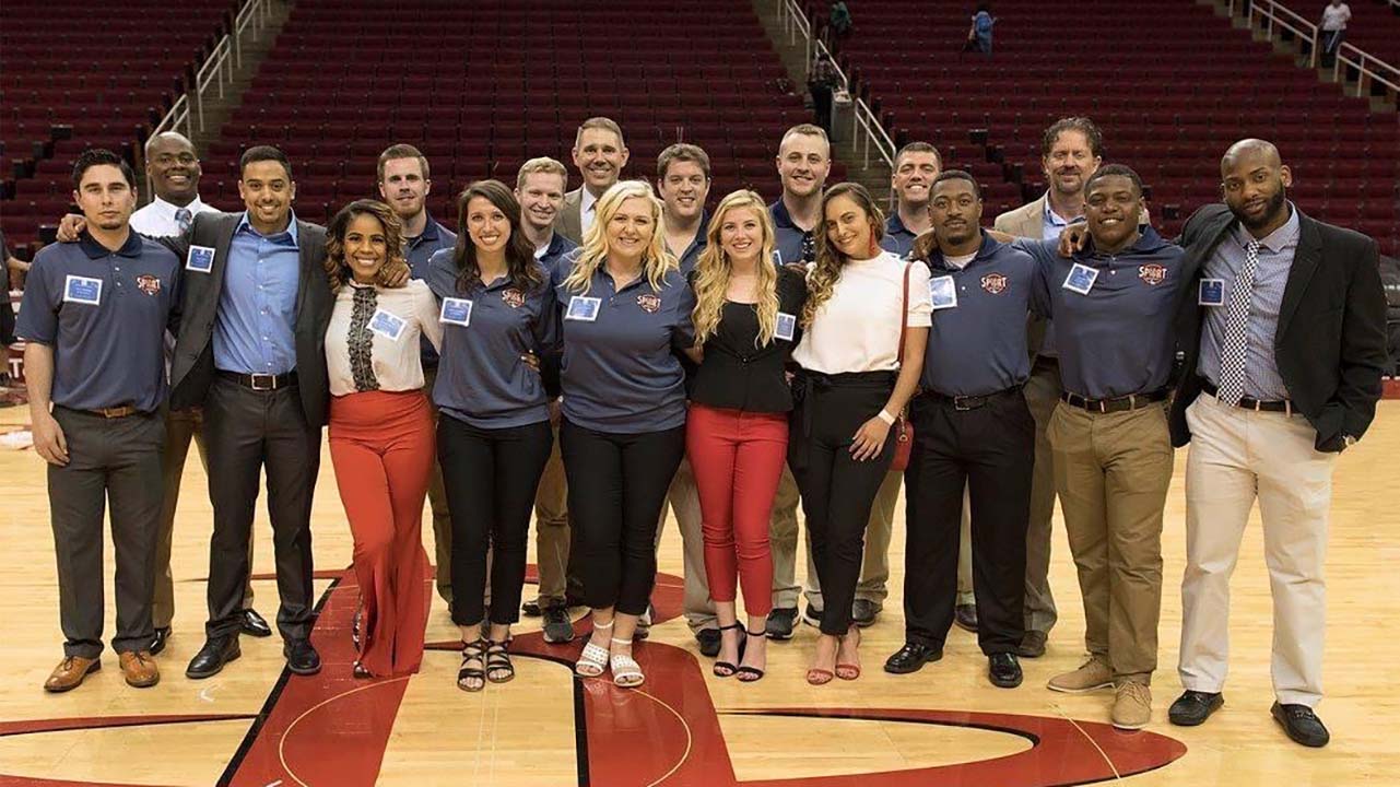 The Sport Management student cohort on the Houston Rocket's court.
