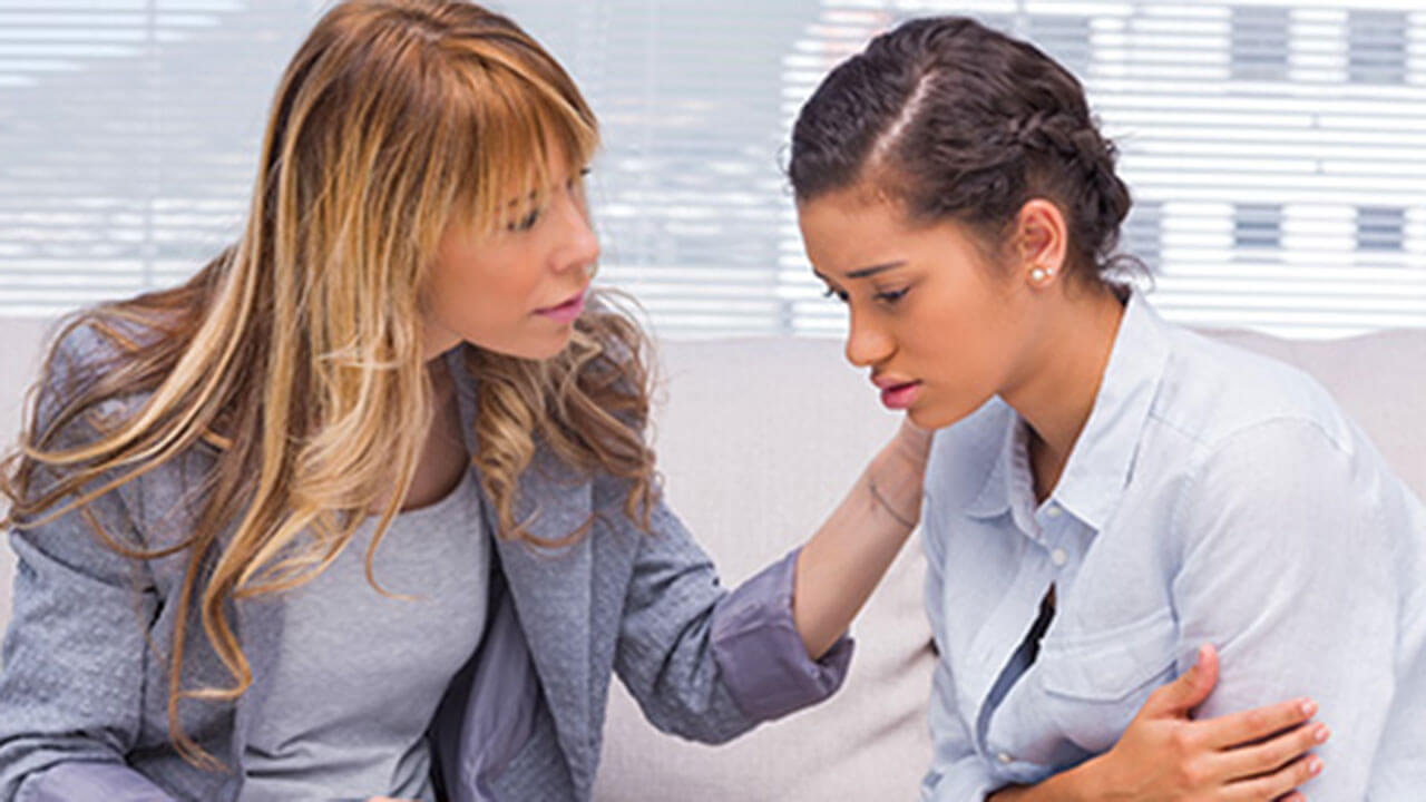 A social worker counsels a victim.