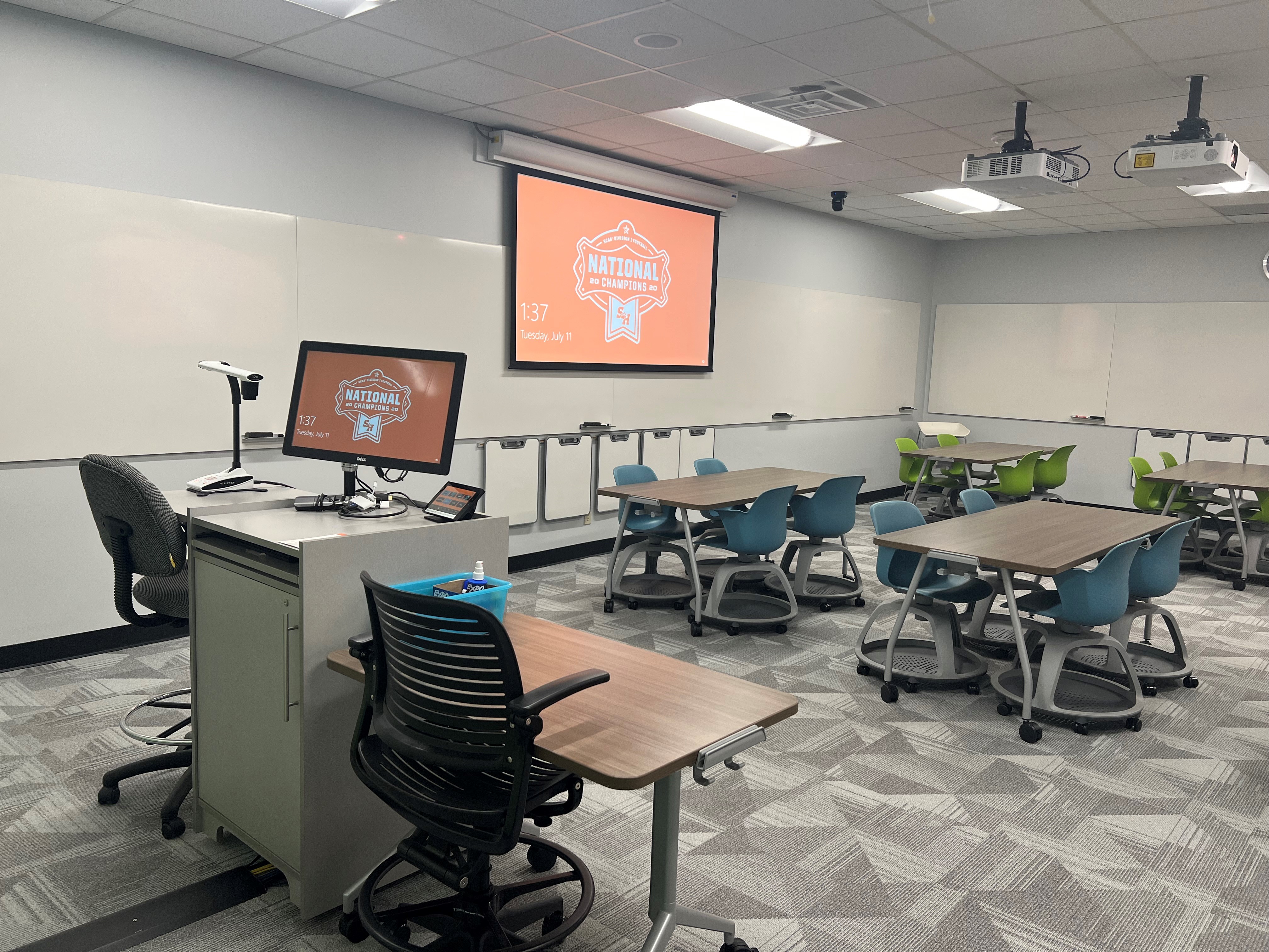 LDB 208, tables and rolling chairs with a instructor computer in the foreground.