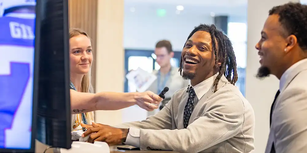 Social media person interviewing student athletes.