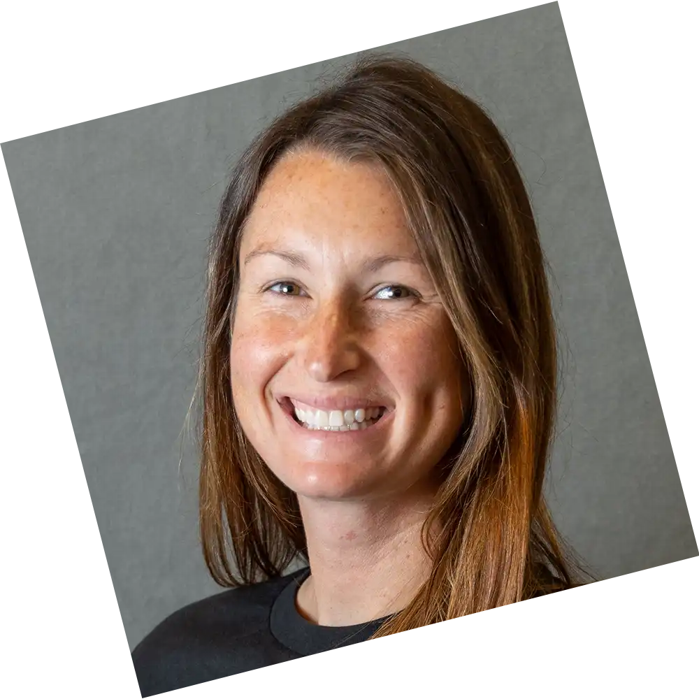 woman with a black suit posing for a headshot