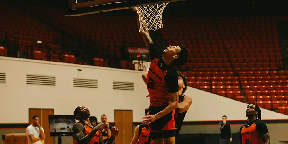 The SHSU men's basketball team practices staff evaluate their performance.