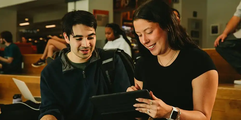 Two SHSU graduate students discuss a class project.