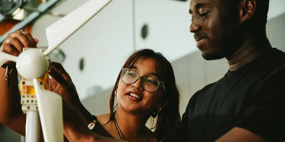 Two SHSU graduate students work on a project