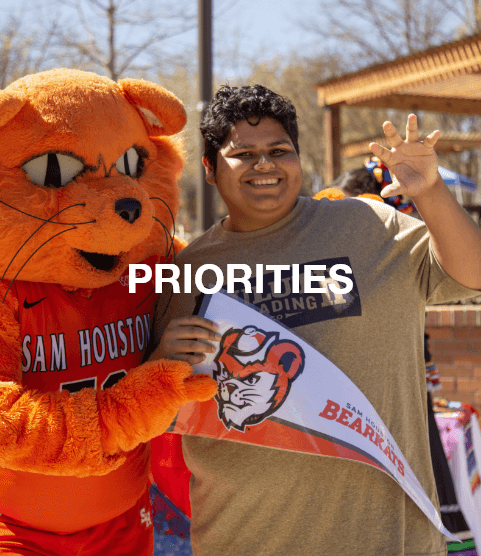 Sammy Bearkat with a student smiling - Priorities