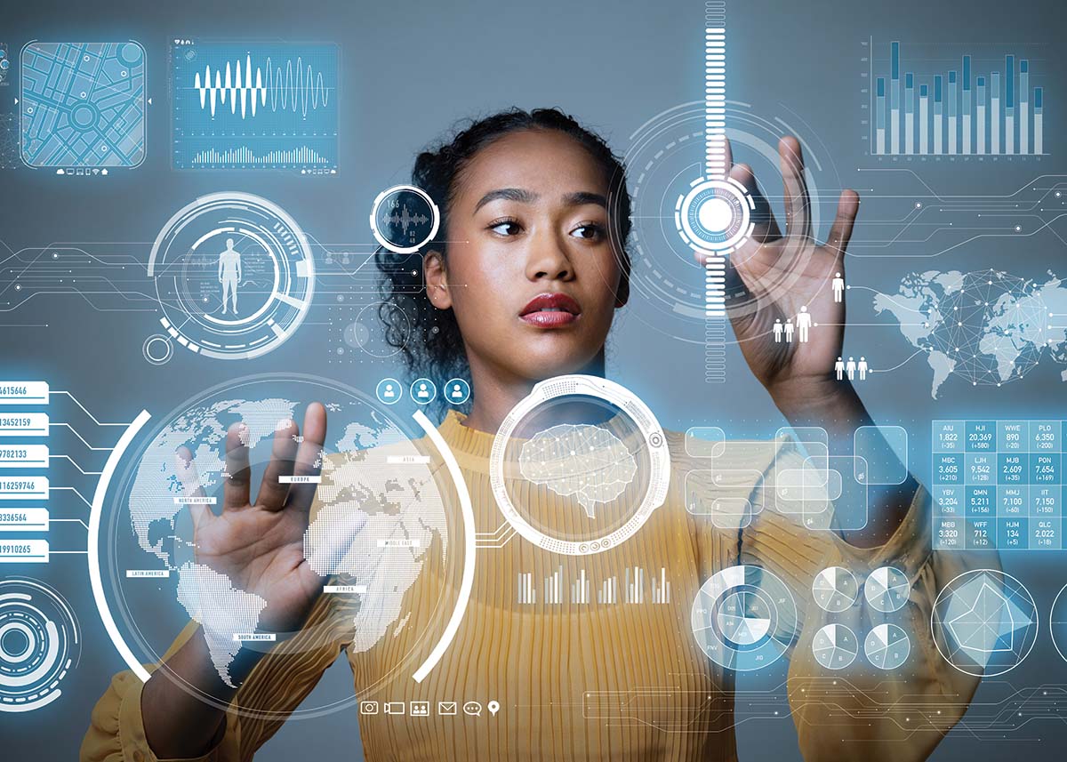 A woman interacts with a holographic user interface on a clear screen in front of her.