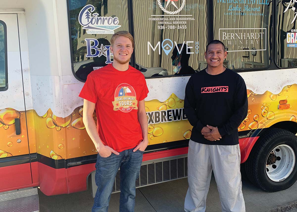 Caleb Corbell & Mike Sanchez stand next to their tour vehicle..