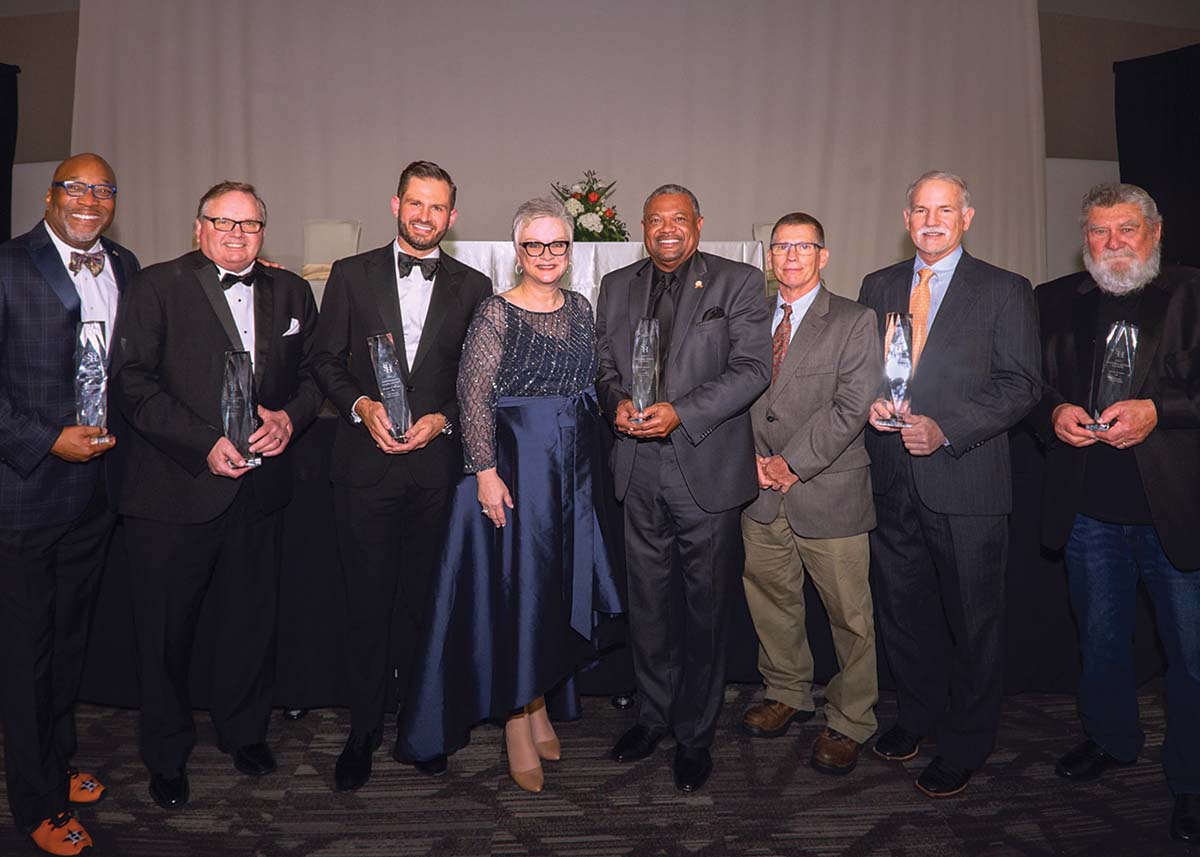 A group of the distinguished alumni award recipients posing with President Alisa White.