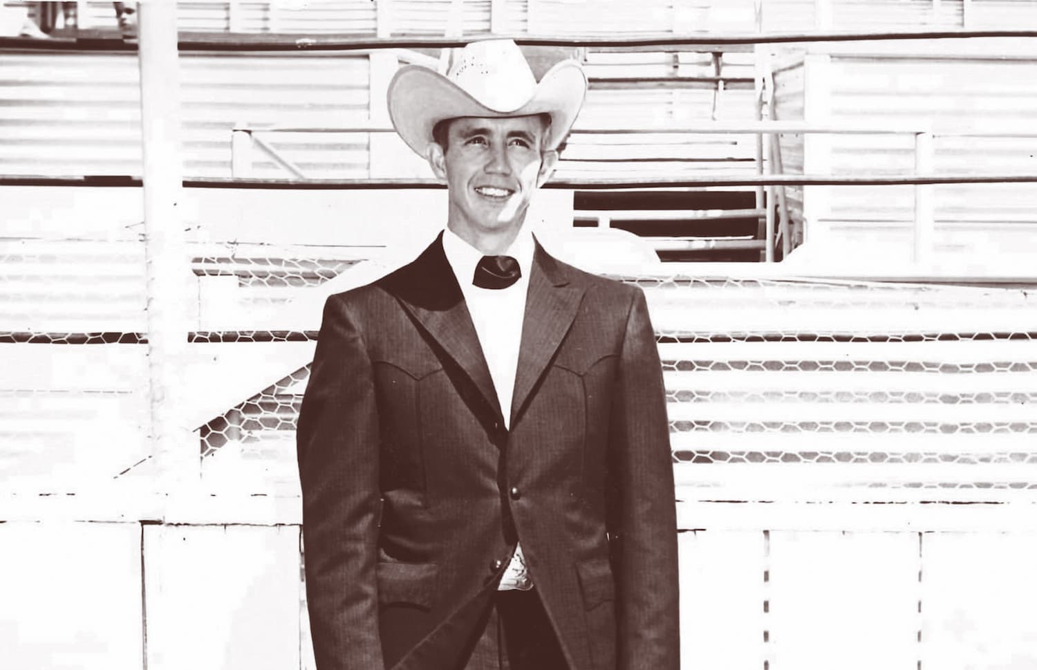 A young Bubba Miller poses at the rodeo in a dapper suit and cowboy hat.