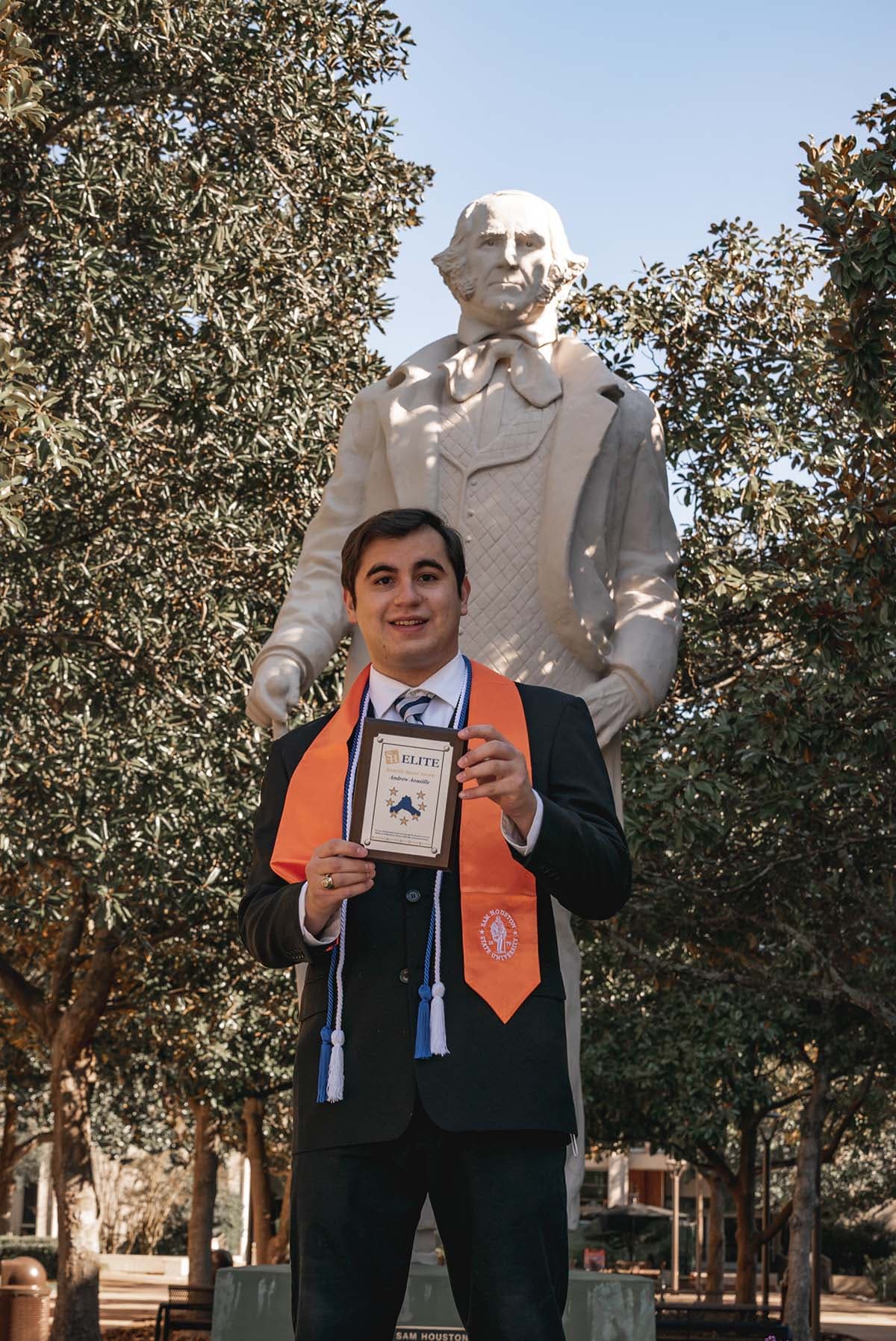 Andrew Aoueille poses in front of the Sam Houston statue in the middle of the SHSU campus.