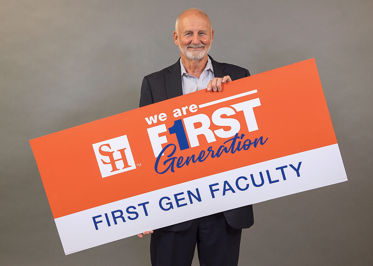 Bobby Lane holding a We Are First Generation sign.