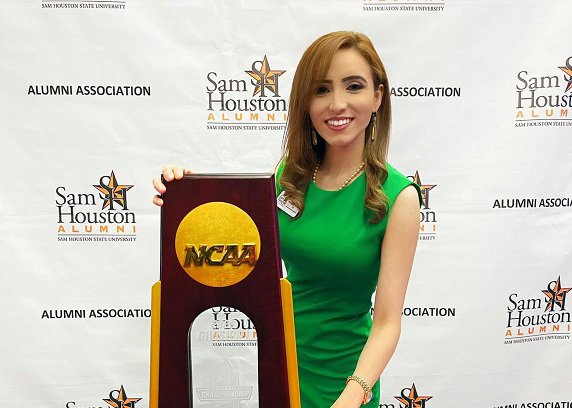 Jessica Rodriguez-Wahlquist posing with the Championship trophy.