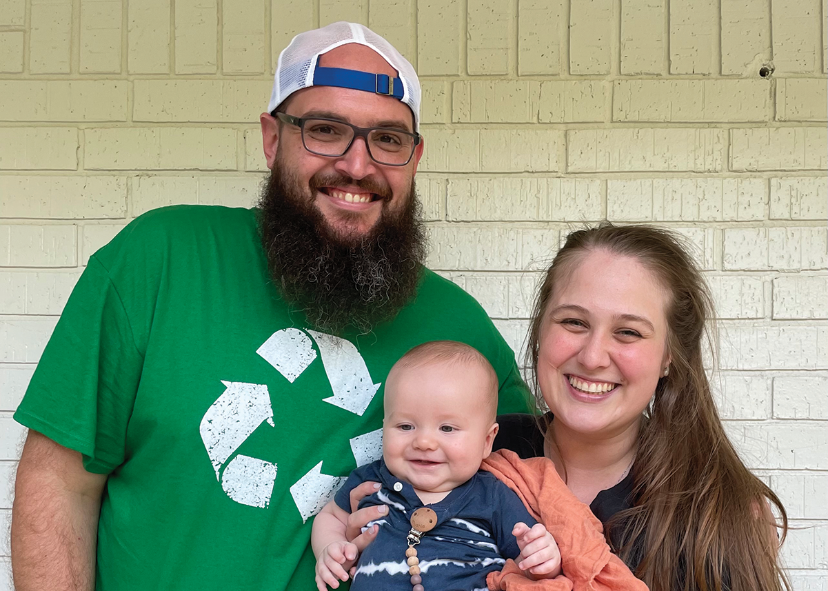 Cody Grubbs Posing with his wife and small child.