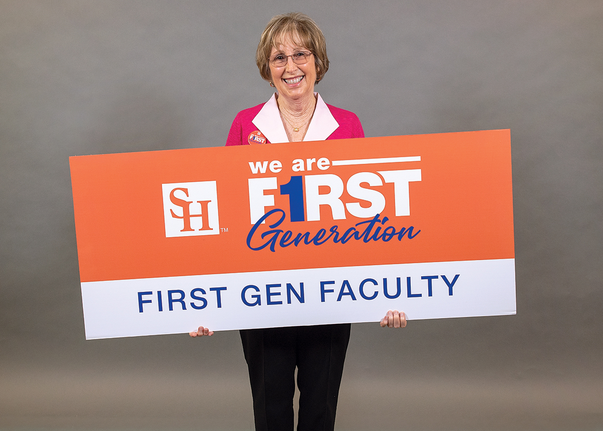 Joyce McCauley holding a We Are First Generation sign.