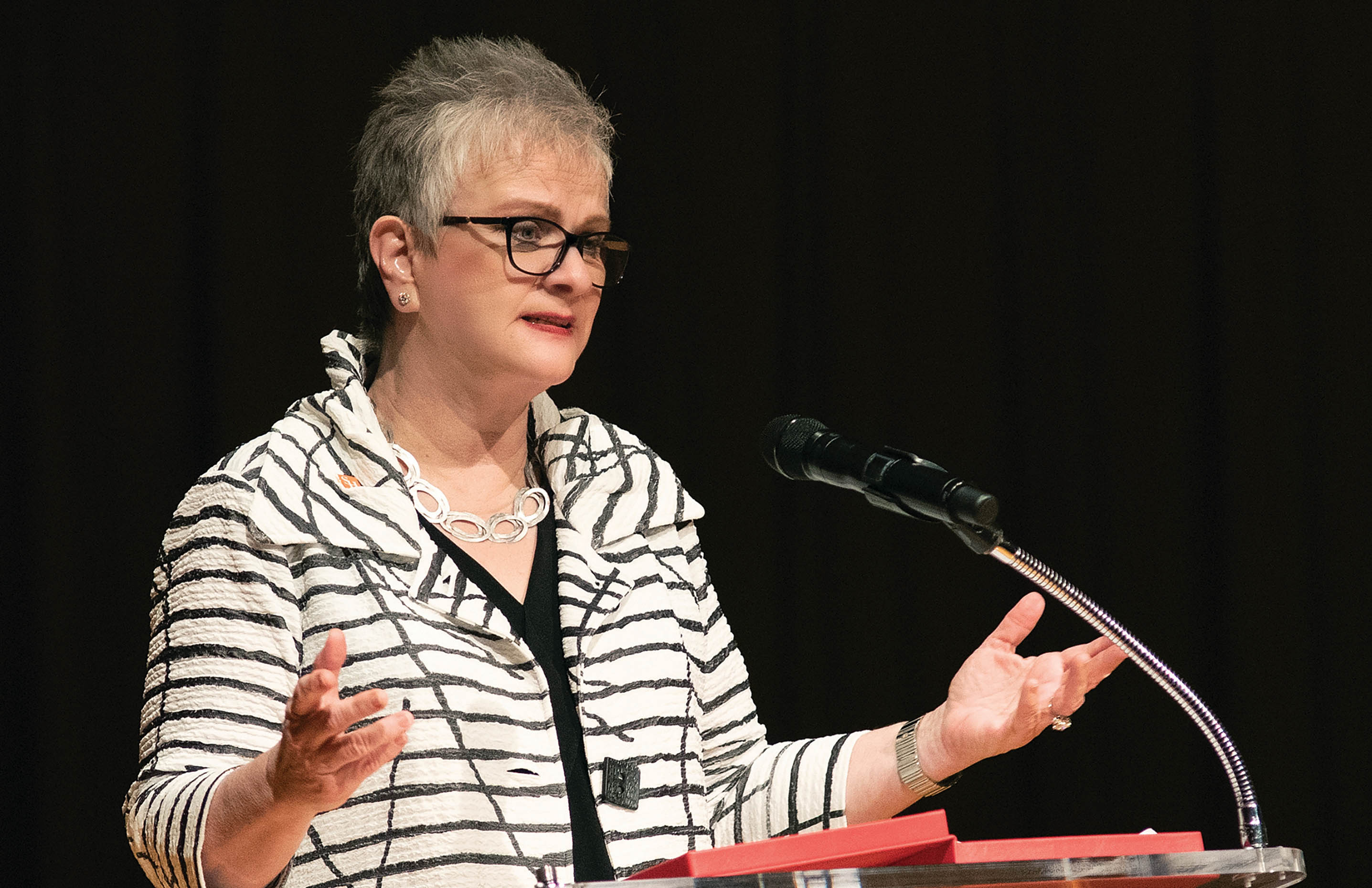 Dr. White speaking at a podium