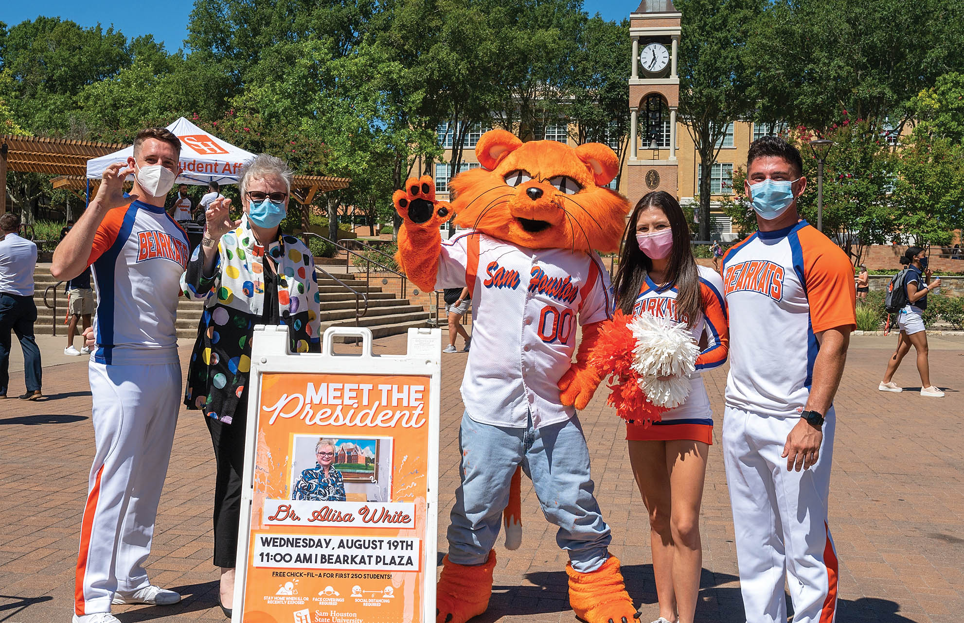 Dr. White, Sammy, and students on campus