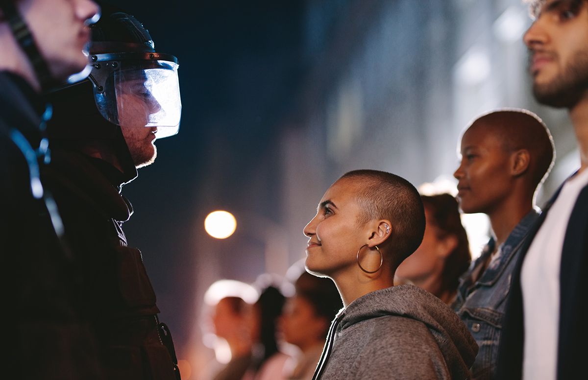 a police officer and a smiling women face each other