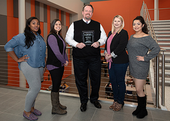 The staff of Student Legal and Mediation Services pose with their award.