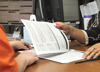 Two people go over Tax papers.