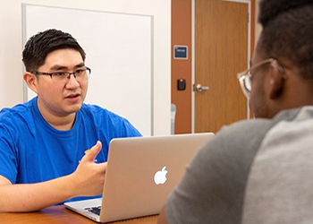 Student working on a laptop in the Academic Success Center.