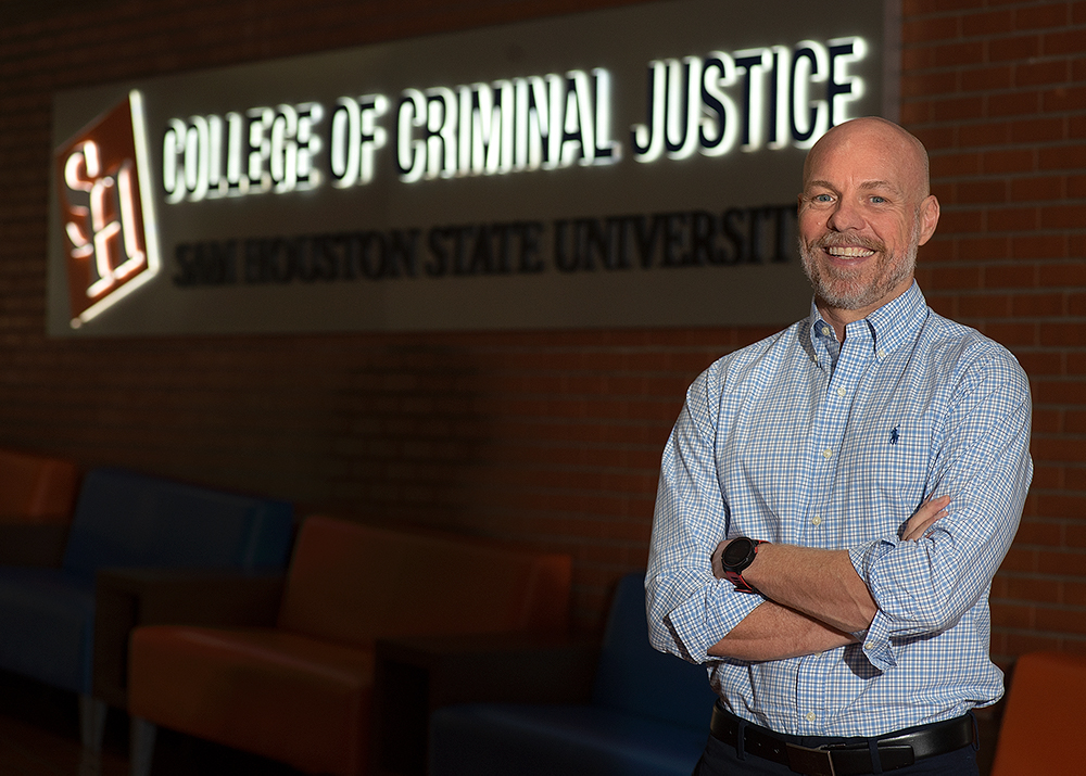 Bill Wells standing in the college of criminal justice center