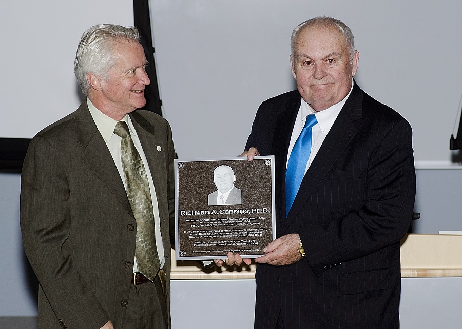 Former dean, John de Castro, presenting Cording with Wall of Honor plaque