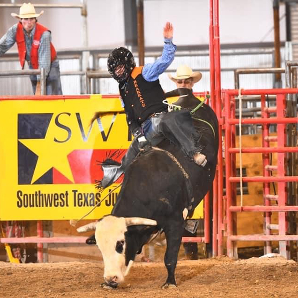 Chris Villanueva competing in bull riding at NIRA Southern Region college rodeo
