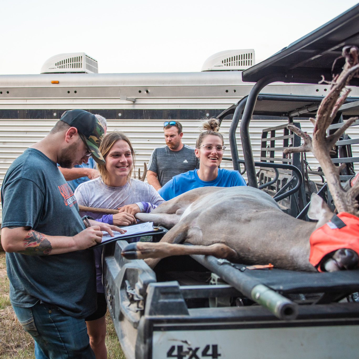 Students and Professor Managing Deer at Ranch