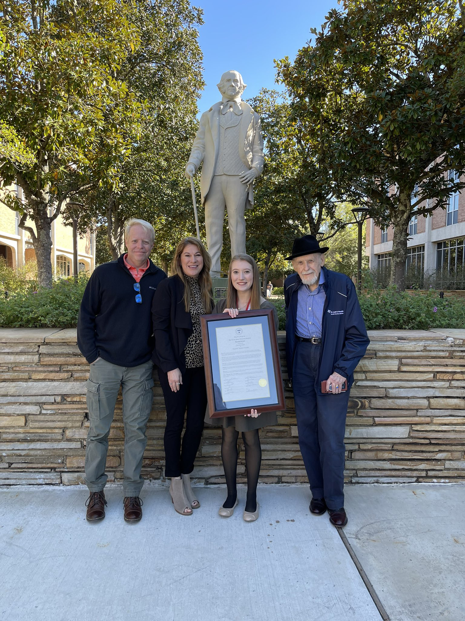 Jess with award by Sam Houston statue