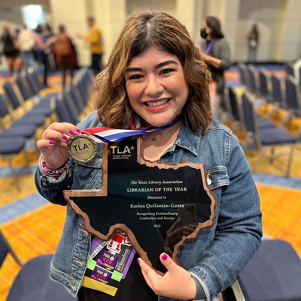 Karina Quilantan-Garza holds award