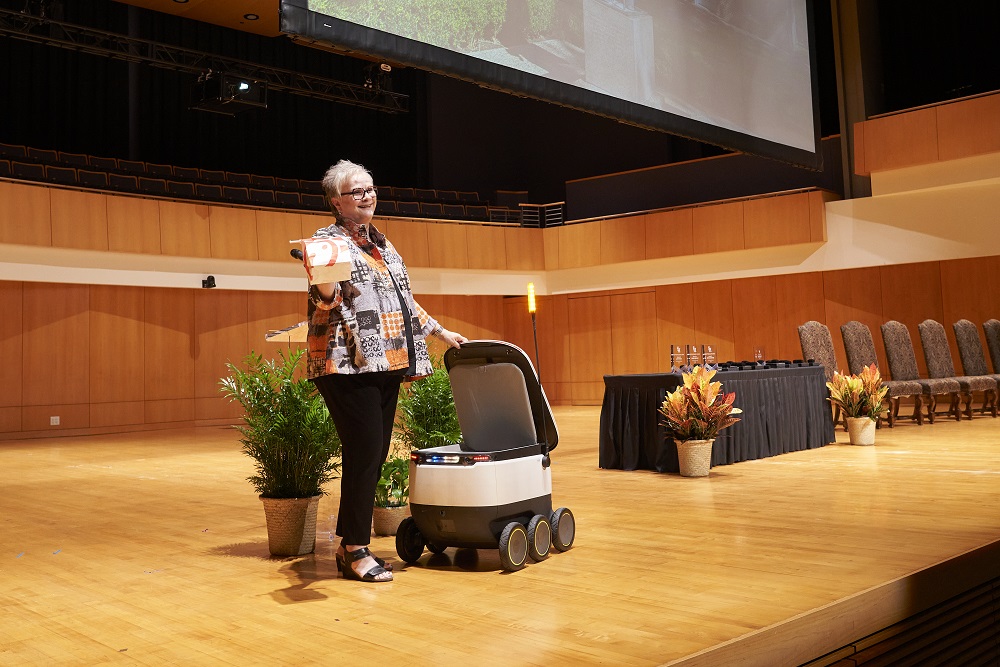 A food delivery robot interrupts President White's address