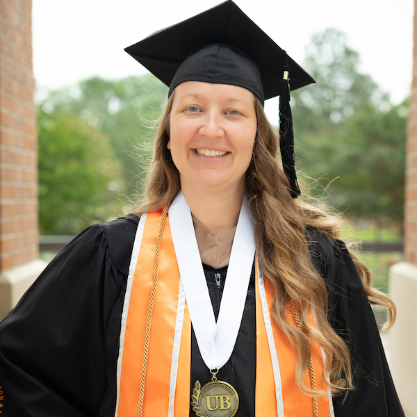 Natali Maness in graduation regalia