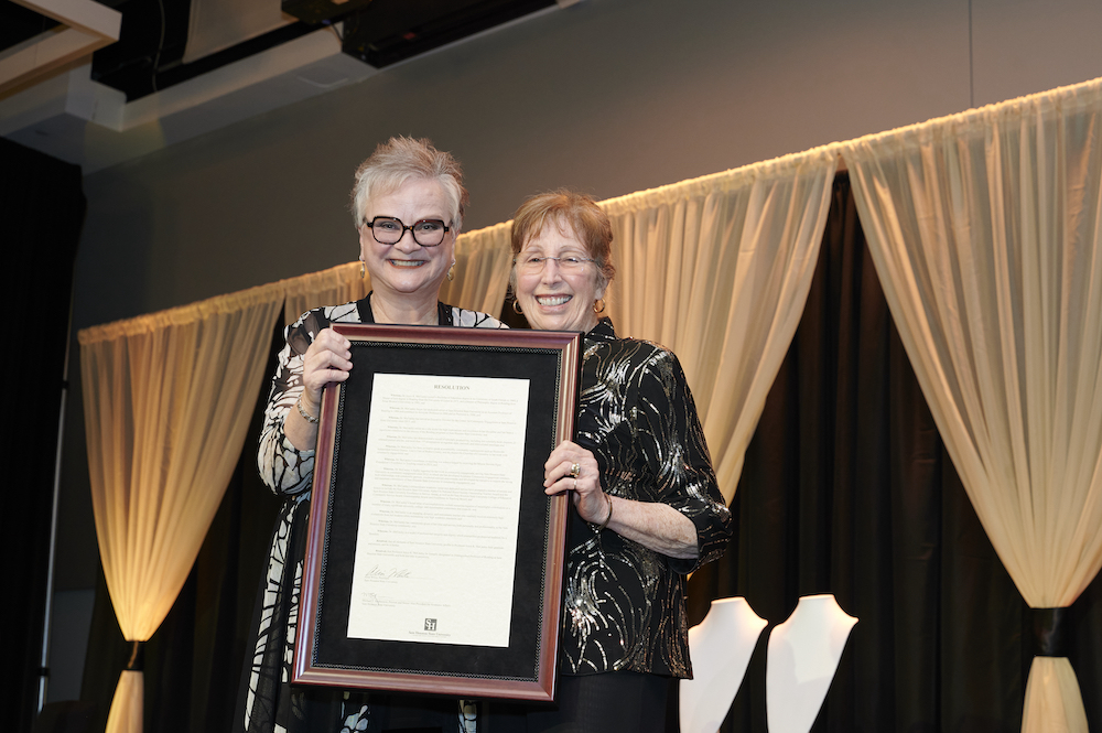 Joyce McCauley, right, takes a photo with University President Alisa White during the Academic Awards Ceremony.